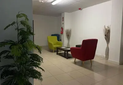 a waiting room with two chairs and a plant at Hostel valencia ruzafa in Valencia