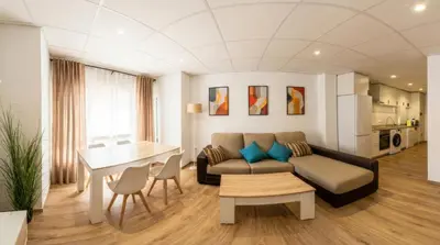 a living room with a couch and a table at Apartamento moderno en el centro de Tavernes in Tavernes de Valldigna