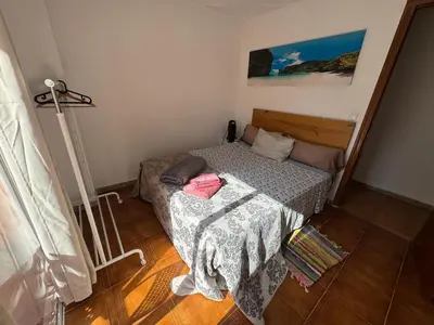 a small bedroom with a bed and a lamp at Albalat Centro in Albalat de la Ribera