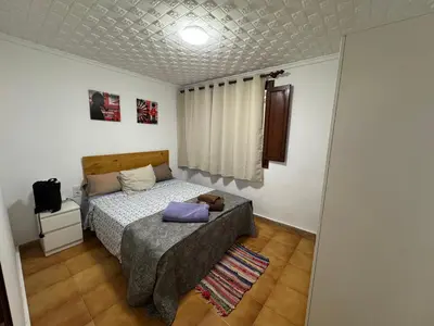 a small bedroom with a bed and a window at Albalat Centro in Albalat de la Ribera