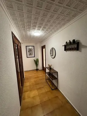 a hallway with a coffered ceiling and a table in a room at Albalat Centro in Albalat de la Ribera