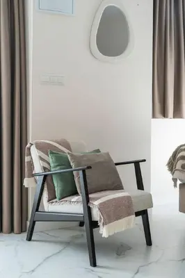 a chair with pillows on it in a living room at Republica Argentina 1 in Valencia
