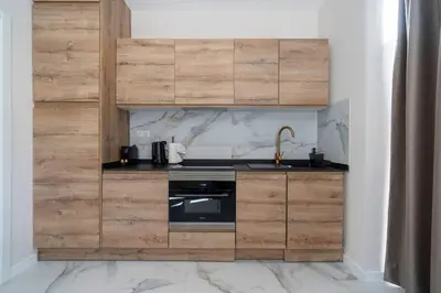 a kitchen with wooden cabinets and a stove at Republica Argentina 1 in Valencia