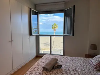 a bedroom with a bed with a view of the beach at Relaxing Sea View Apartment - Patacona Beach in Valencia