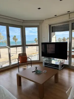 a living room with a tv and a coffee table at Relaxing Sea View Apartment - Patacona Beach in Valencia