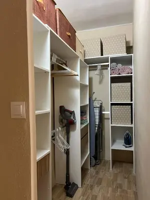 a walk in closet with white shelves at Pearl by the sea in Valencia