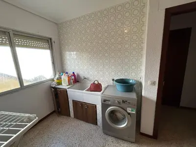 a kitchen with a washing machine and a sink at Apartamento Perellonet Mascaró in El Perellonet