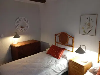 a bedroom with a bed and a dresser and two lamps at Casa La Villa in Requena