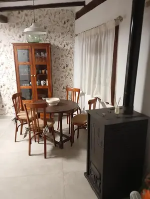a dining room with a table and chairs and a television at Casa La Villa in Requena