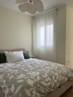a living room with a table and chairs and a tv at Puzol Playa in Puzol