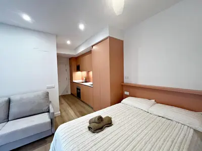 a bedroom with a bed with a stuffed animal on it at Loft en el Centro De Valencia Botánico 3 in Valencia