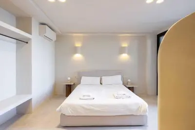 a bedroom with a white bed and two tables at VLC Host - Reina 166 B in Valencia