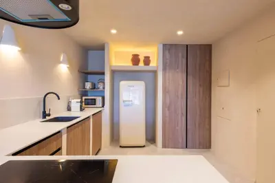 a kitchen with a refrigerator in the middle of it at VLC Host - Reina 166 B in Valencia