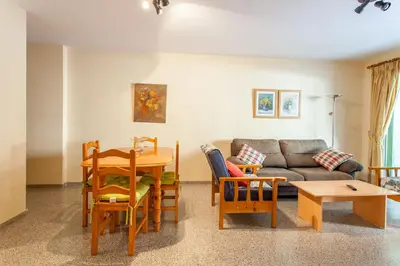 a living room with a couch and a table and chairs at Apartment Patacona Beach 7 in Valencia