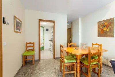 a dining room with a wooden table and chairs at Apartment Patacona Beach 7 in Valencia