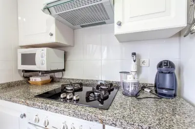 a kitchen counter with a stove and a blender at Apartment Patacona Beach 6 in Valencia