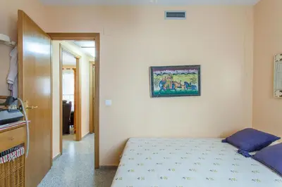 a bedroom with a bed and a picture on the wall at Apartment Patacona Beach 6 in Valencia