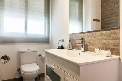 a bathroom with a sink and a toilet and a mirror at Apartment Ruzafa Market I in Valencia