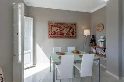 a dining room with a blue table and white chairs at Apartment Ruzafa Market I in Valencia