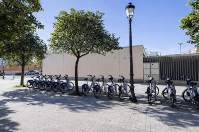 a row of bikes parked next to a street light at Roig Arena Suite Garden N9 in Valencia