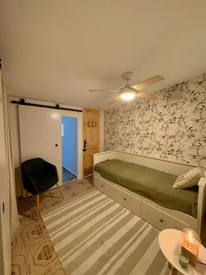 a bed sitting in a corner of a room at Las Casitas de Cullera Sol y Mar in Cullera
