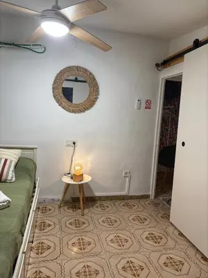 a bathroom with a toilet and a sink and a mirror at Las Casitas de Cullera Sol y Mar in Cullera