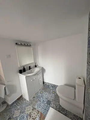 a bathroom with a white sink and a toilet at Las Casitas de Cullera Sol y Mar in Cullera