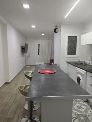 a kitchen with a table with a red plate on it at Valencia Room in Cuart de Poblet