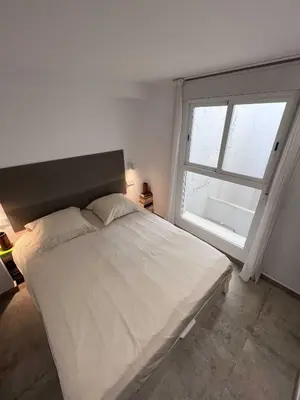 a bedroom with a large bed with a large window at Centro Histórico - Beneficencia Flat in Valencia