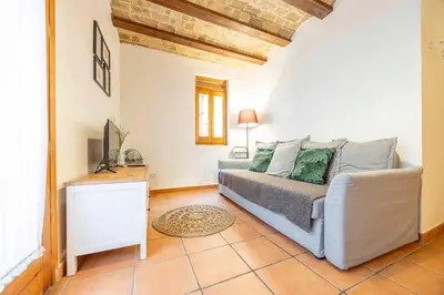 a bedroom with a bed and a television in it at Valencia Flat Rental 1 bedroom apartment historical center in Valencia