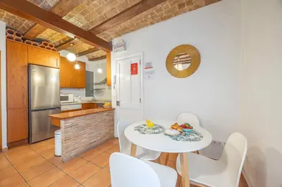 a kitchen and dining room with a white table and chairs at Valencia Flat Rental 1 bedroom apartment historical center in Valencia