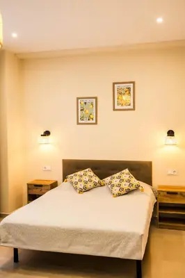 a dining room with a table and a bedroom at Canoa Studio Valencia in Valencia