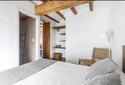 a bedroom with a white bed and a chair at superincreible ubicación in Valencia