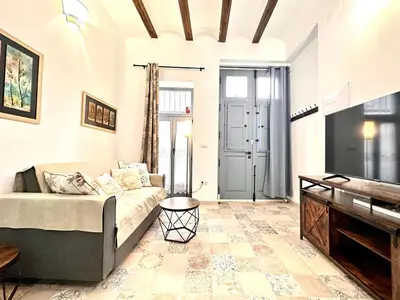 a living room with a couch and a piano at Season apartment Cabañal in Valencia