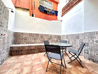 a patio with a table and chairs and a tub at Season apartment Cabañal in Valencia