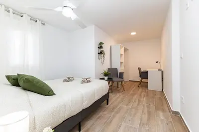 a bedroom with a bed and a dining room at Monte Tulum in Torrent