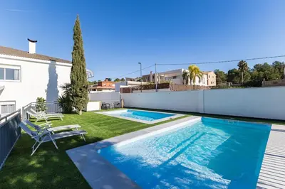 a swimming pool in the backyard of a house at Monte Alban Experience a unique place in Torrent