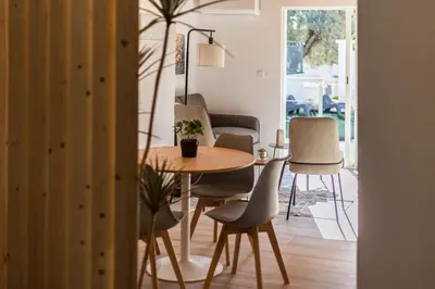 a dining room with a table and chairs at Loft Sayulita Escapada moderna en el paraíso in Torrent