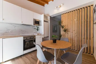a kitchen with a table and chairs in a room at Loft Sayulita Escapada moderna en el paraíso in Torrent
