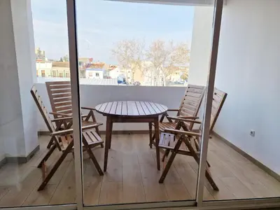two chairs and a table on a balcony at Cabanyal playa las arenas apartamento reformado in Valencia