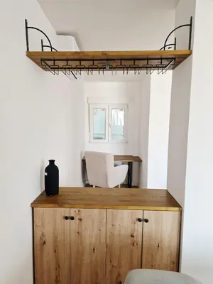 a room with a desk and a shelf at Cabanyal playa las arenas apartamento reformado in Valencia