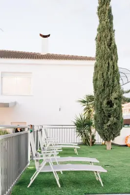 a patio with a table and chairs on the grass at Riviera Esmeralda Relax y belleza en un solo lugar in Torrent