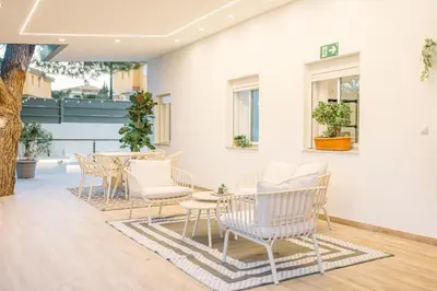 a group of chairs and tables in a room with a tree at Riviera Esmeralda Relax y belleza en un solo lugar in Torrent
