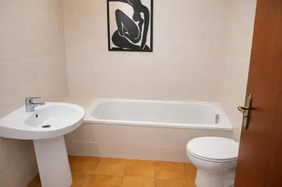 a bathroom with a sink and a tub and a toilet at Winahost Casita Tavernes de Valldigna in Tavernes de Valldigna