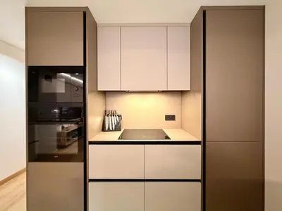 a kitchen with white cabinets and a sink at Sunny Waves Apartment in Cullera