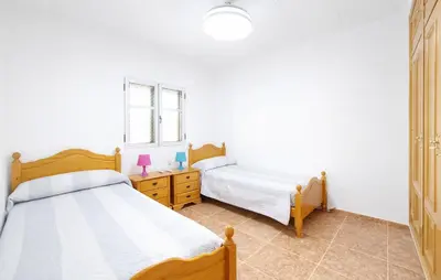a bedroom with two beds and a dresser at 4 Bedroom Stunning Home In Sueca in Sueca