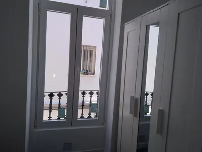 two windows in a room with a view of a balcony at La Corona de Valencia in Valencia