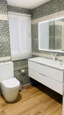a bathroom with a toilet and a tub and a sink at Stylish Bright Centrally Located Home El Botanic in Valencia