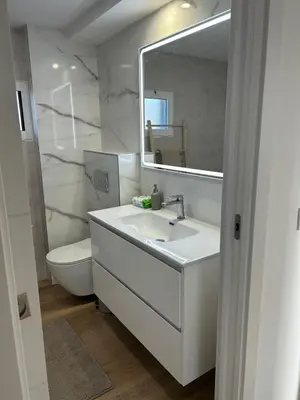 a bathroom with a sink and a toilet and a mirror at Villa Noelia in Turís