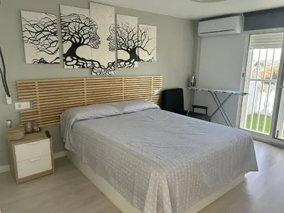 a bedroom with a bed and two trees on the wall at Villa Noelia in Turís